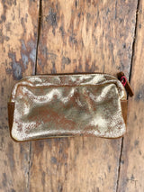 Photo of back of metallic gold leather cosmetic bag